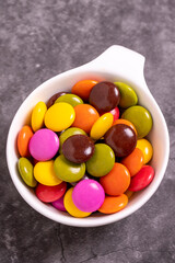 Colorful candies or bonbon. Chocolate filled candy on a dark background. close up