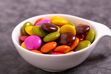 Colorful candies or bonbon. Chocolate filled candy on a dark background. close up