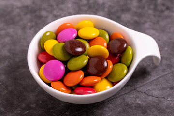 Colorful candies or bonbon. Chocolate filled candy on a dark background. close up
