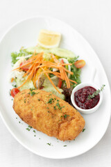 chicken cordon bleu with salad and cranberry sauce