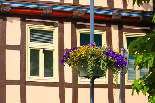 Colorful flower pots in the streets of the old town of Burg in Magdeburg, Saxony Anhalt, Germany