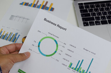 Fototapeta premium Business document chart report financial and graph statistic analysis management information and research investment plan sale on desk at office.