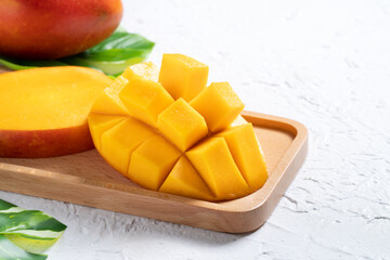 Mango background design concept. Top view Diced fresh mango fruit on white table.