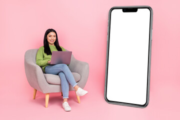 Full size photo of funny millennial lady type laptop wear pullover jeans shoes isolated on pink background