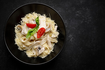 Fetuchini alfredo with mushrooms and chicken in creamy cheese sauce