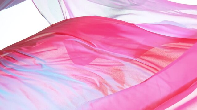 Pastel color transparent silk fabric flowing by wind, super slow motion filmed on high speed cinematic camera at 1000 fps.