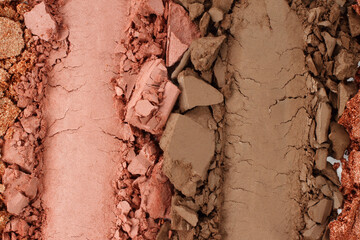 Broken and smashed make-up eyeshadow pallete, lay of brush strokes, close-up for background, top view