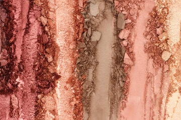 Broken and smashed make-up eyeshadow pallete, lay of brush strokes, close-up for background, top view