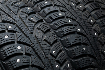 Car tires close-up with traces of operation. Partial reflection of spikes. Replacement of tires