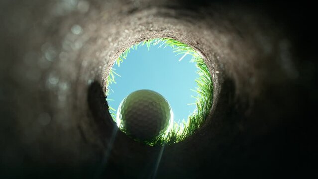 Super Slow Motion Shot of Golf Ball Falling Down Through Clay Hole at 1000 fps.