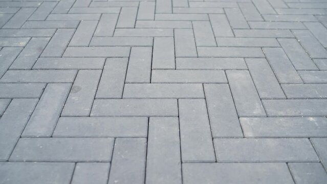 Trowel for laying floor tiles. Alignment of sand mortar on paving stones. Fine sand is poured into the cracks of paving slabs.