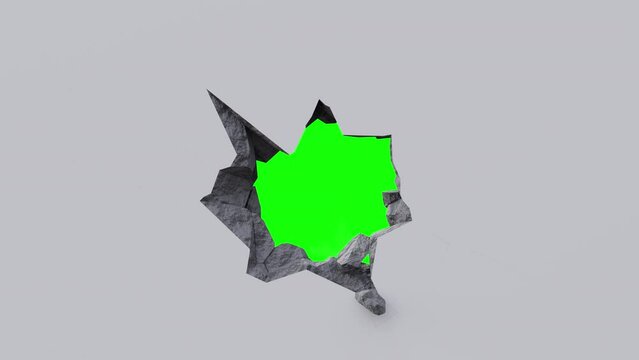 breaking a wall on a green background. wall explodes and reveals a green background. destruction of a wall close-up
