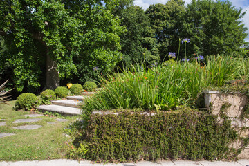 Modern garden design and landscaping:Park and hillside plot with a staircase made of natural stones...