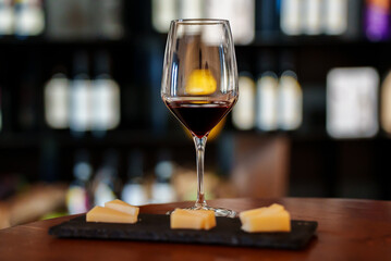Glass of red wine and cheese.