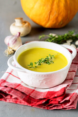 Tasty Pumpkin Soup with Cream on Gray Background Raw Pumpkin Herbs Garlic Vertical