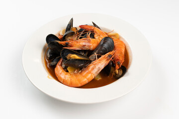 Schezwan Prawns in black bowl at dark slate background. Schezwan Prawns is indo-chinese cuisine curry dish with prawns or shrimps roasted in Schezwan Sauce.