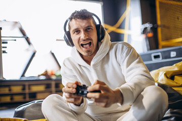 man playing video game and wearing headphones