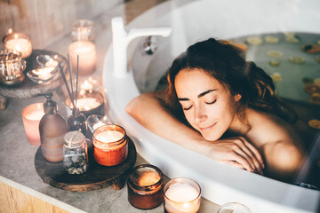 Beautiful woman relaxing at spa. Young lady relaxing in jacuzzi. - obrazy, fototapety, plakaty