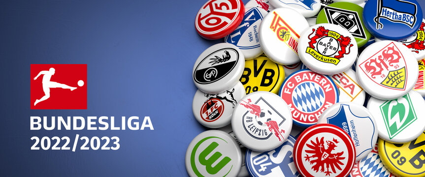 Logos of the German Soccer Clubs competing in the Bundesliga season 22/23 on a heap on a table. Copy space. Web banner format