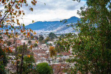 San Cristóbal de las Casas -Cityscape perspective peeking through the trees. San Cristobal is a highland town with colourful and well-preserved colonial architecture in Chiapas, southern Mexico.