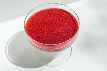 Red vegan ice dessert in glass creamer