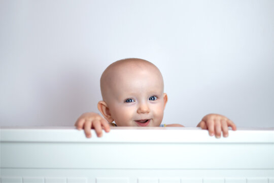 cute cute baby peeking out on white background.