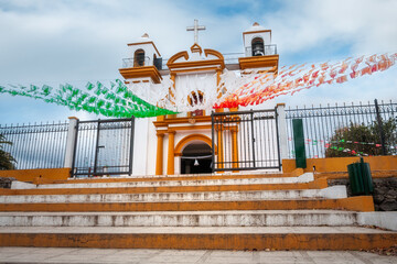 Church of Our Lady of Guadalupe-Low-level perspective from the staircase leading to the colourful church in San Cristobal de las Casas, Mexico. The highland town is known for its colonial architecture