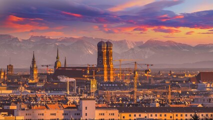 Fototapeta premium Munich skyline aerial view at sunset colored sky, munich germany frauenkirche marienplatz alps mountains.