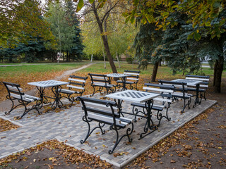 A playground with tables for playing chess in a city park. Ukraine, Chuguev