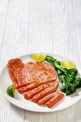 fried tuna steak with boiled broccolini and lime