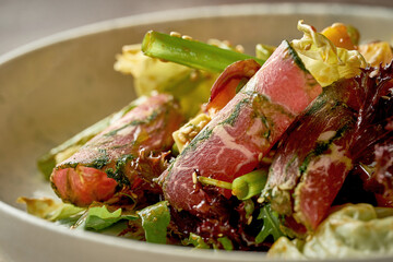 Salad with roastbeef and mango with hot sauce. Close-up, post-production noise. Selective focus