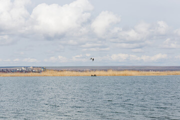 from afar you can see the city and the sky and beautiful blue clouds against the backdrop of a beautiful blue lake