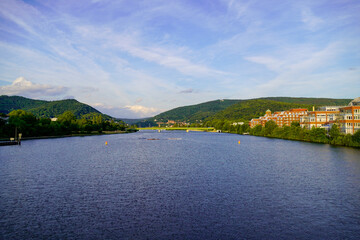 View of the Neckar and Heidelberg from the Wehrsteg Wieblingen. Weir on the Neckar. Pedestrian and bike path.
