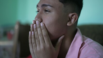 Fototapeta na wymiar One anxious hispanic young man covering face with regret emotion