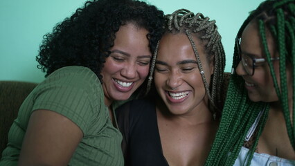 Happy female friends embrace. Three happy black African women laughing and smiling