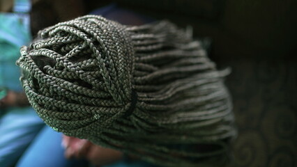 Box braided hairstyle. Green dreadlocks. One black latina young woman with fashion cool hair