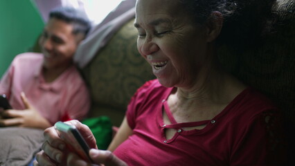 Fototapeta premium A senior woman talking on phone laughing and smiling. A hispanic latin south american older person using cellphone