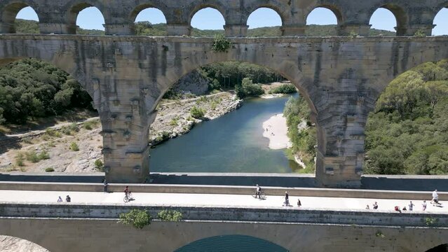 Drone flying through The Pont du Gard, an ancient Roman aqueduct in France