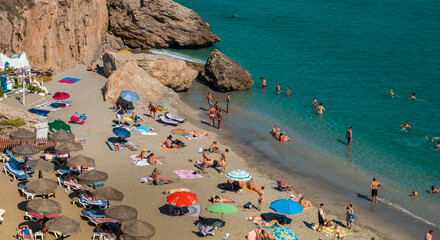 NERJA, Spain - September 18, 2021: View of the beautiful beach of Nerja in Spain on Summer - obrazy, fototapety, plakaty