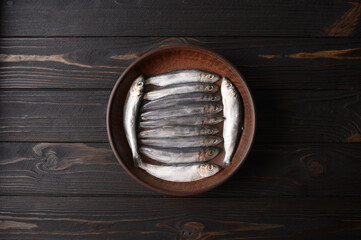 Fresh herring on rustic wooden background, close up shot