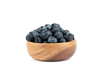 Wooden bowl full of blueberry or bilberry or blackberry or blue whortleberry or huckleberry isolated on white background.