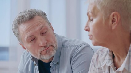 Sad couple calculating budget, feeling stressed about financial situation