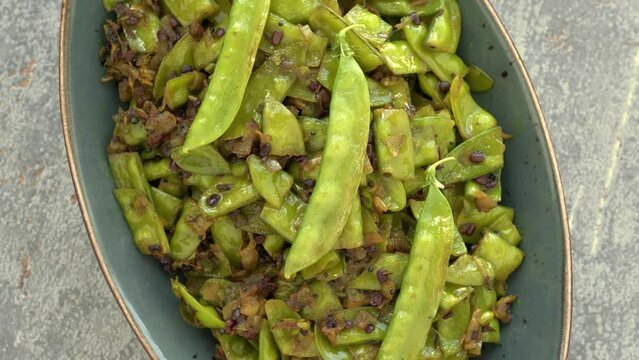 Sugar peas poriyal (sugar peas thoran) meal. Asian cuisine style food. Table spin.