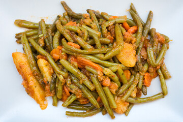 traditional Greek food, green beans, onion and potatoes stewed in tomato, herbs and olive oil, fasolakia ladera in Greece