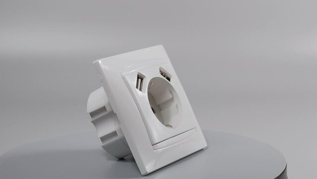Socket with two USB Socket with two USB connectors. 220 volt European standard socket with two usb connectors for charging mobile devices. White plastic socket on a white background.. High quality 4k 