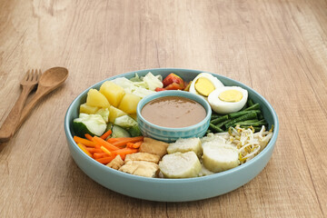 Gado Gado, Indonesian traditional vegetable salad with peanut sauce, rice cake, tofu and egg
