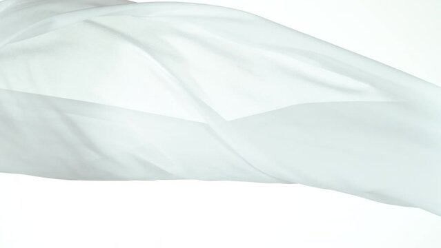 White transparent silk fabric flowing by wind, super slow motion filmed on high speed cinematic camera at 1000 fps.