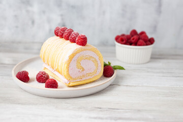 Tasty roll cake, sponge roll, Swiss roll  stuffed with cream cheese ,decorated with fresh...