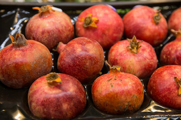 Fototapeta na wymiar Seasonal fruits at the agricultural market, pomegranates