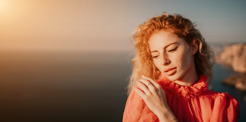 Close up shot of beautiful young caucasian woman with curly blond hair and freckles looking at...